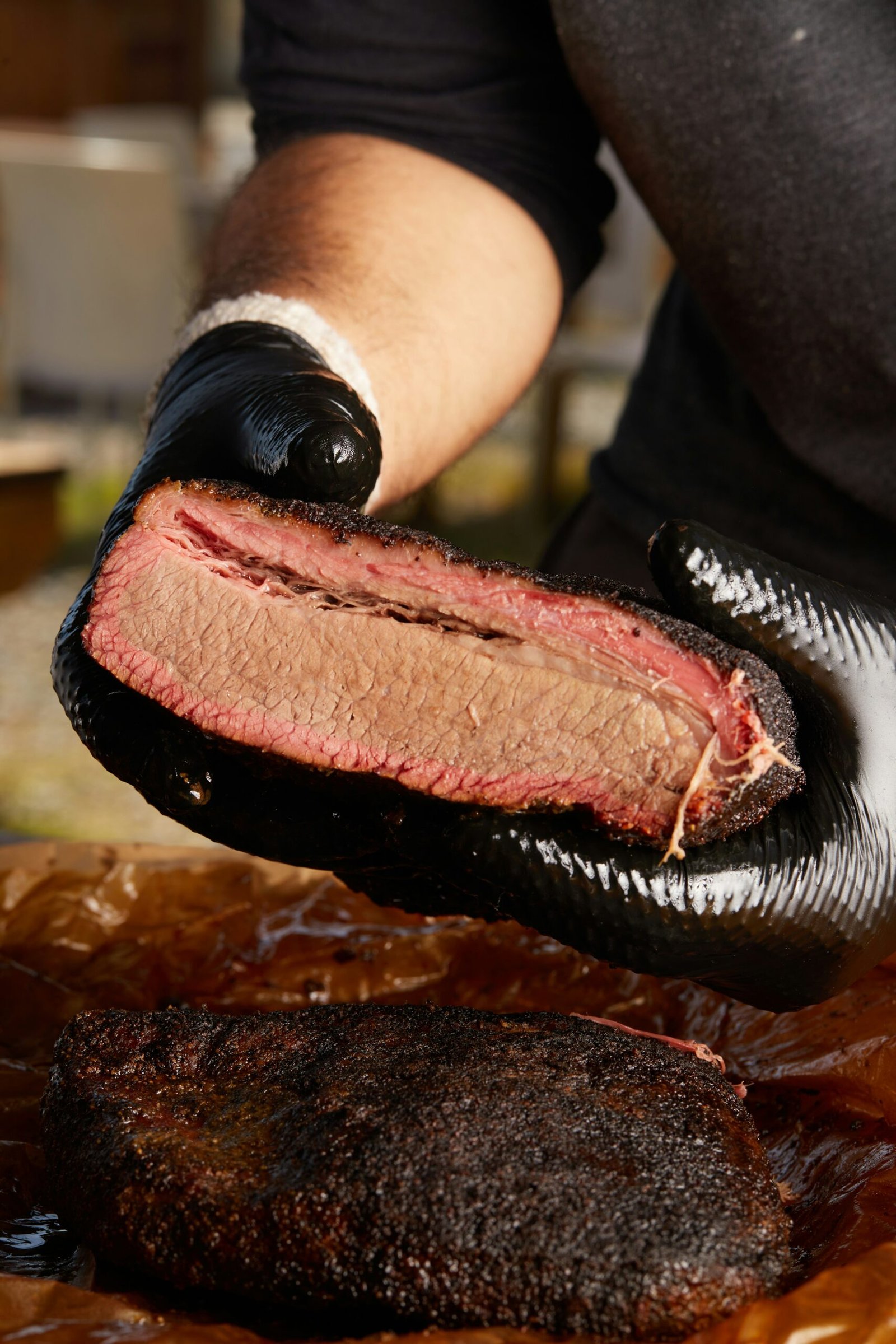 person holding raw meat during daytime